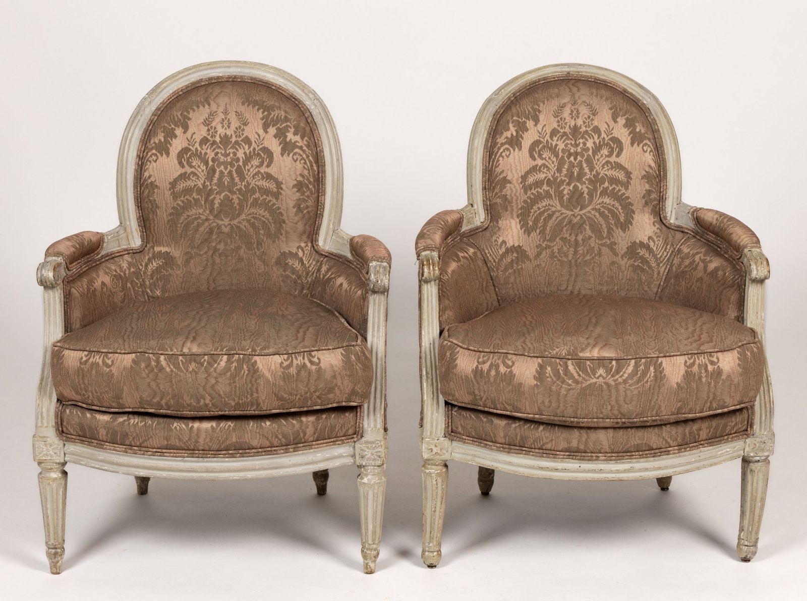 PAIR OF PAINTED FRENCH LOUIS XVI BREGERE ARMCHAIRS IN SILK DAMASK: PAIR OF PAINTED FRENCH LOUIS XVI BREGERE ARMCHAIRS IN SILK DAMASK, featuring oval backs leading into a rounded back form with closed arms, upholstered with moire silk damask, having generously-stuffed