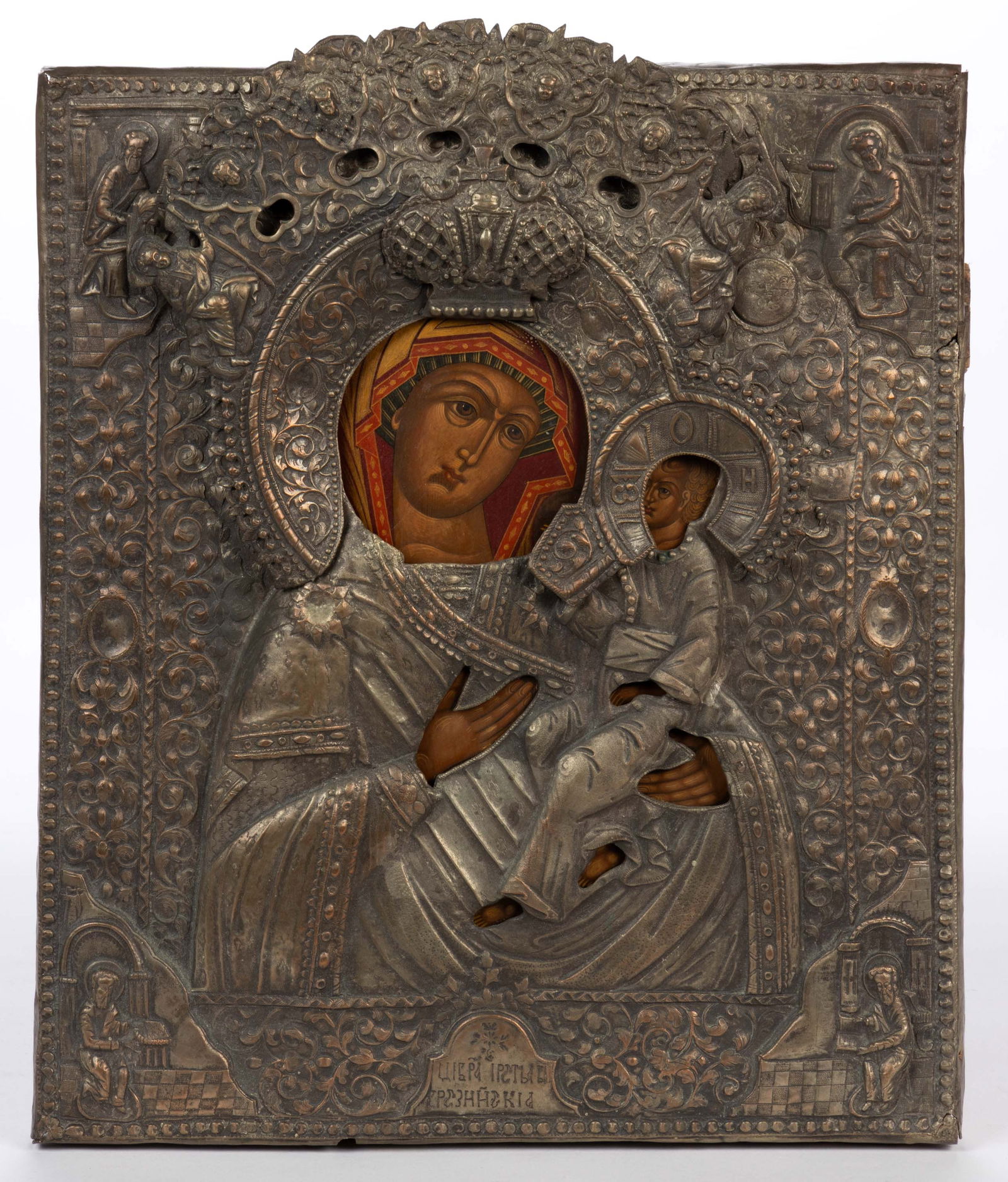 RUSSIAN ORTHODOX MADONNA AND CHILD ICON: RUSSIAN ORTHODOX MADONNA AND CHILD ICON, punched and repousse-decorated silvered-copper riza framing the painted surface featuring faces and hands, applied copper "halo" framing faces,