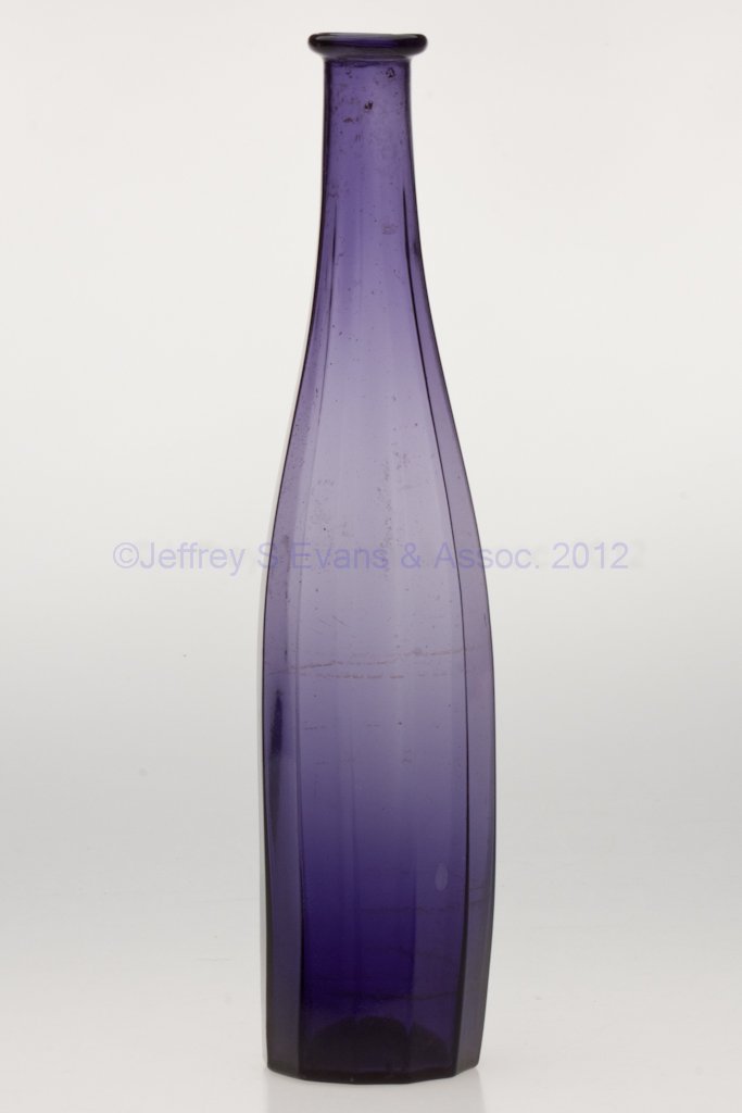 BLOWN-MOLDED PANELED COMMERCIAL COLOGNE BOTTLE: BLOWN-MOLDED PANELED COMMERCIAL COLOGNE BOTTLE, medium violet, high lead content, tall, tapered 12-panel form with folded mouth and rough pontil mark. Boston & Sandwich Glass Co., Patrick Slane's Amer