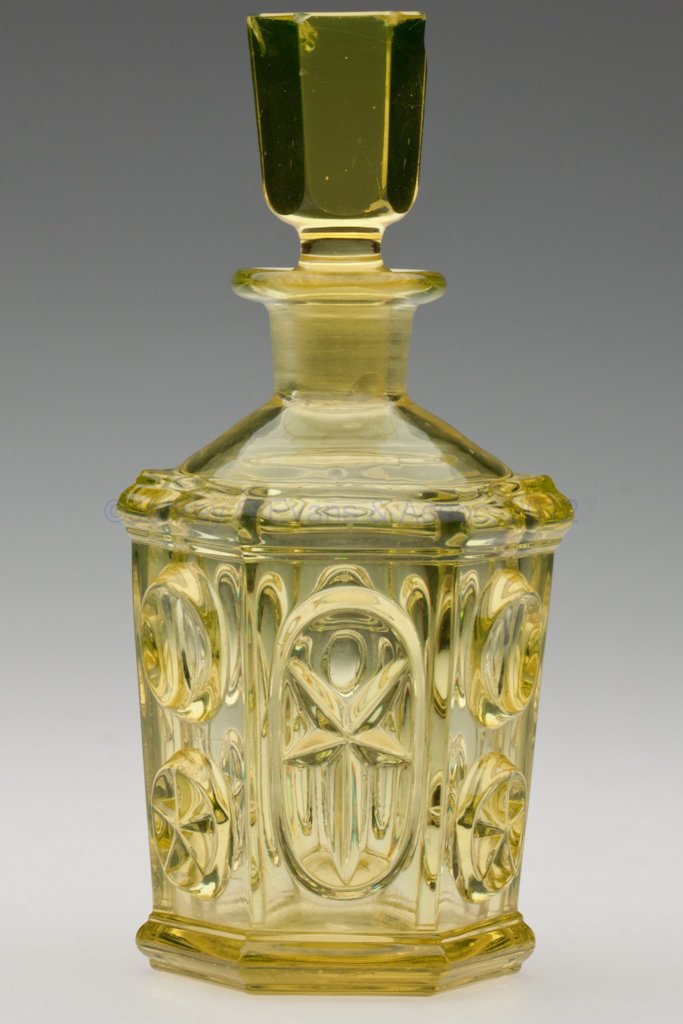 PRESSED STAR AND PUNTY COLOGNE BOTTLE: PRESSED STAR AND PUNTY COLOGNE BOTTLE, canary yellow, hexagonal form produced from the same mold as the stand lamp small font, polished pontil mark, original panel-cut solid stopper. Stopper numbered 