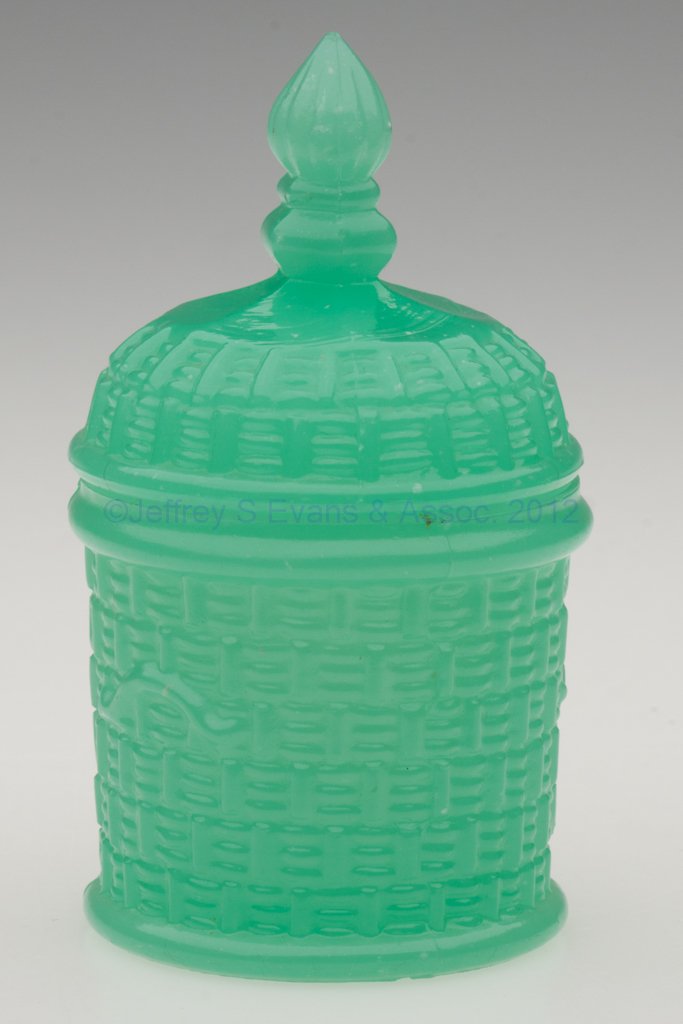 PRESSED COVERED BASKET POMADE / TOOTHPICK HOLDER: PRESSED COVERED BASKET POMADE / TOOTHPICK HOLDER, translucent jade green, small size, base with decorative handles, cover with a ribbed and knopped finial. Boston & Sandwich Glass Co. 1850-1870. 4" HO
