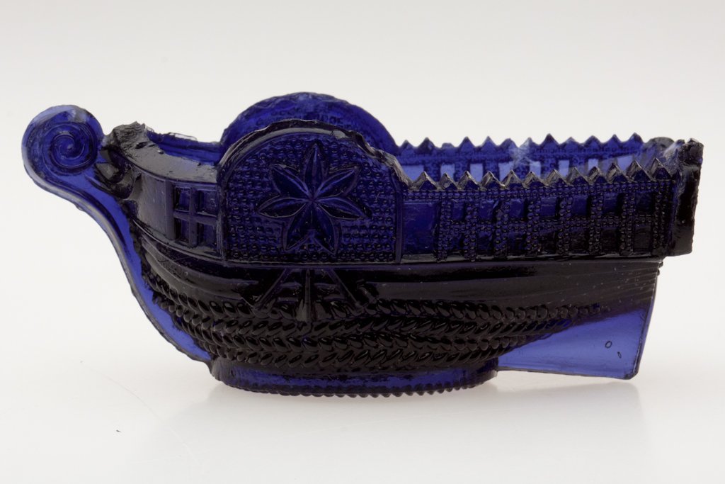 BT-2 "PITTSBURGH." STEAMBOAT PRESSED SALT: BT-2 "PITTSBURGH." STEAMBOAT PRESSED SALT, deep purple blue, embossed on stern, rope table ring. Very rare. Attributed to the Stourbridge Flint Glass Works, Pittsburgh, PA. 1830-1845. 1 1/2" H, 1 7/8"