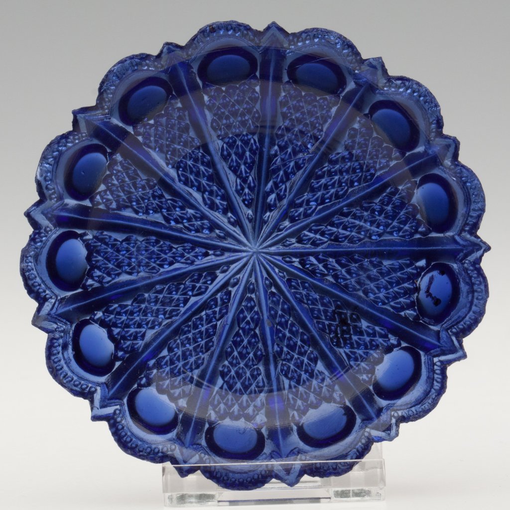 CD-1 PEACOCK EYE PRESSED UNDERPLATE FOR SALT: CD-1 PEACOCK EYE PRESSED UNDERPLATE FOR SALT, unlisted violet blue, scallop and point rim with tiny beads underneath. Possibly unique. Attributed to the Boston & Sandwich Glass Co. 1830-1845. 3/4" H, 