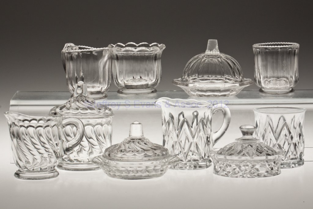VARIOUS TOY TABLE ARTICLES, LOT OF TEN: VARIOUS TOY TABLE ARTICLES, LOT OF TEN, colorless, comprising a Colonial four-piece table set, sugar lacking cover; a three-piece Twist table set with a butter dish, covered sugar bowl, and creamer; a