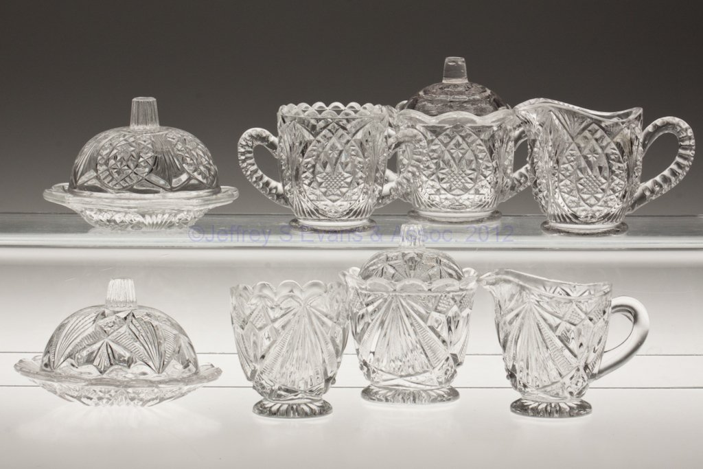 VARIOUS PATTERN TOY FOUR-PIECE TABLE SETS, LOT OF : VARIOUS PATTERN TOY FOUR-PIECE TABLE SETS, LOT OF TWO, colorless, comprising a Rex and a Style, each with a butter dish, covered sugar bowl, creamer and spooner. Fourth quarter 19th century. 2 1/8" to