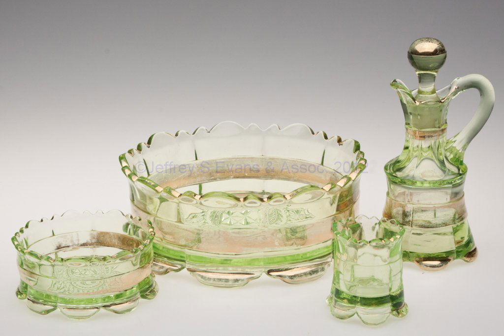 RANSON TABLE ARTICLES, LOT OF FOUR: RANSON TABLE ARTICLES, LOT OF FOUR, vaseline with gilt decoration, comprising a cruet with matching stopper, a master berry bowl and one individual berry dish, and a toothpick holder. Riverside Glass