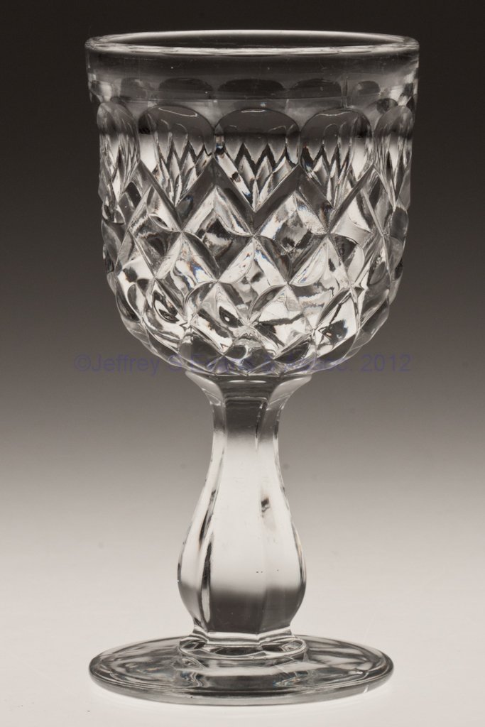 BAKEWELL BLOCK CHAMPAGNE GLASS: BAKEWELL BLOCK CHAMPAGNE GLASS, colorless lead glass. Third quarter 19th century. 5 1/8" H. Collection of Walter "Bud" Marchant.