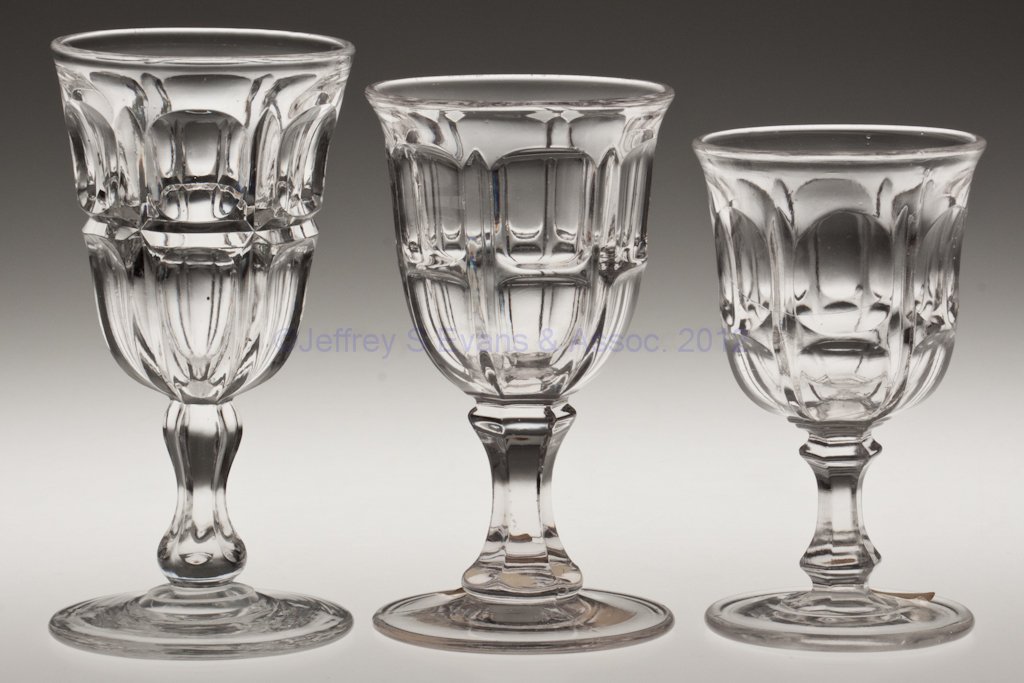 BIGLER STEMS, LOT OF THREE: BIGLER STEMS, LOT OF THREE, colorless lead glass, comprising Bigler and Grooved Bigler champagnes, and a Bigler claret. Two examples with polished pontil marks. Third quarter 19th century. 4 5/8" to 5