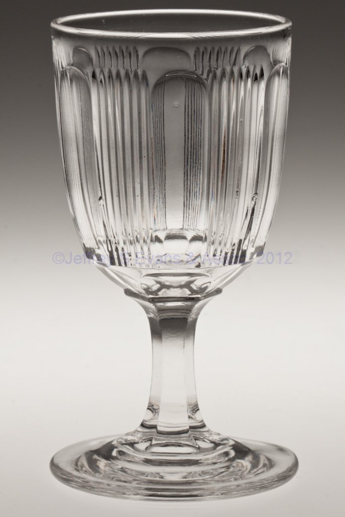 PANELED FINETOOTH CHAMPAGNE GLASS: PANELED FINETOOTH CHAMPAGNE GLASS, colorless lead glass. Third quarter 19th century. 5 1/4" H. Collection of Walter "Bud" Marchant