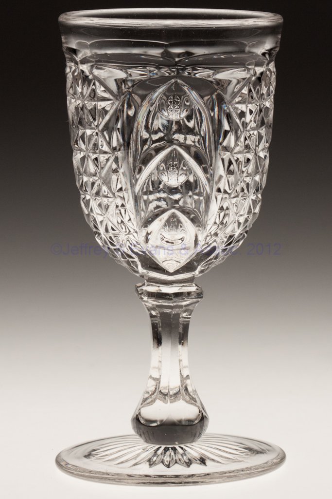 SCARAB - RAYED FOOT CHAMPAGNE GLASS: SCARAB - RAYED FOOT CHAMPAGNE GLASS, colorless lead glass. Third quarter 19th century. 5 1/2" H. Provenance: Collection of Walter "Bud" Marchant.