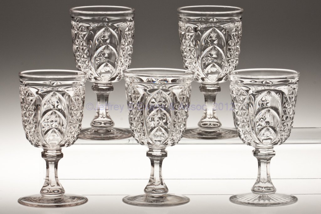 SCARAB ASSEMBLED SET OF FIVE GOBLETS: SCARAB ASSEMBLED SET OF FIVE GOBLETS, colorless lead glass, one example with a rayed foot. Third quarter 19th century. 6 1/8" to 6 3/8" H. Provenance: Lillian "Lil" and Walter "Bud" Marchant Collectio