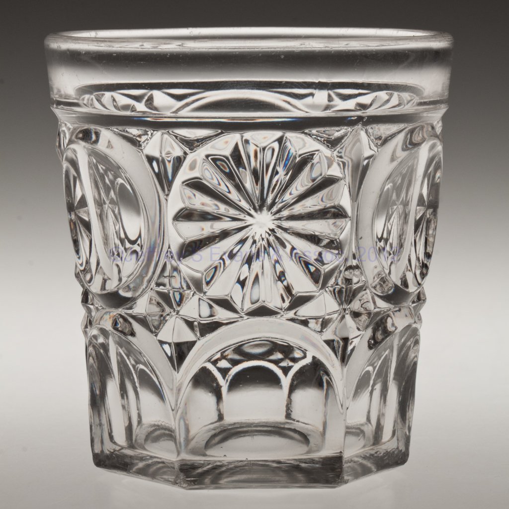 BULL'S EYE AND ROSETTE WATER TUMBLER: BULL'S EYE AND ROSETTE WATER TUMBLER, colorless lead glass, polished pontil mark. Third quarter 19th century. 3 1/2" H. Provenance: Lillian "Lil" and Walter "Bud" Marchant Collection/Lil-Bud Antiques.