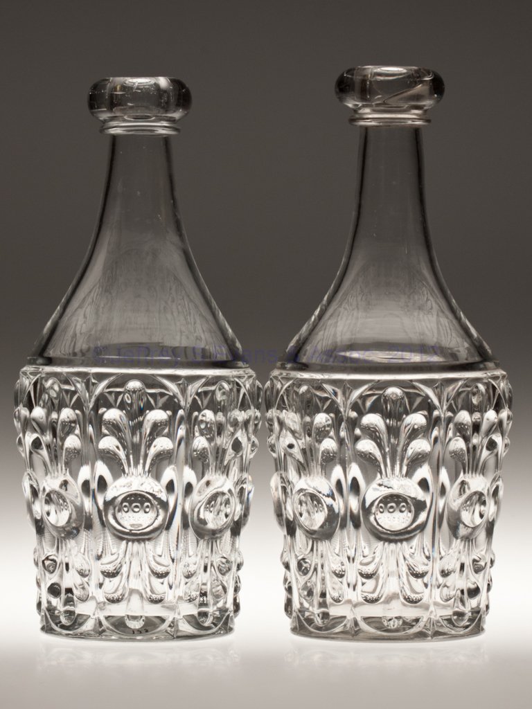 BULL'S EYE WITH FLEUR-DE-LYS PAIR OF QUART DECANTE: BULL'S EYE WITH FLEUR-DE-LYS PAIR OF QUART DECANTERS, colorless lead glass, each with applied bar lip and polished pontil mark. Boston and Sandwich Glass Co. and others. Third quarter 19th century. 10