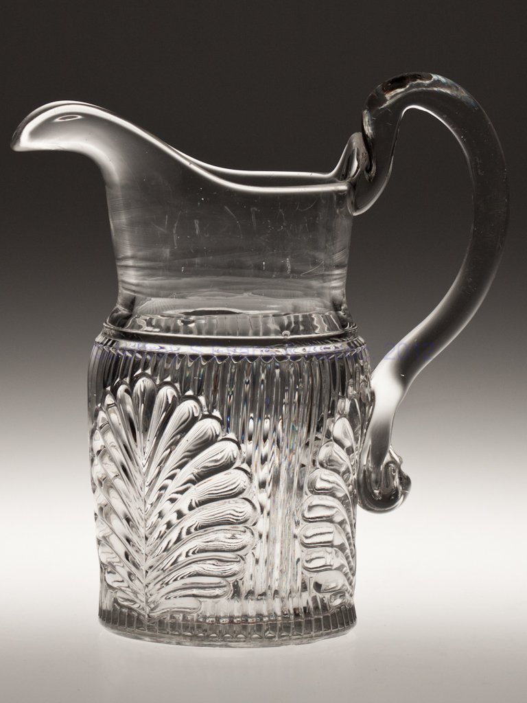 RIBBED PALM / SPRIG (OMN) WATER PITCHER: RIBBED PALM / SPRIG (OMN) WATER PITCHER, colorless lead glass, applied handle, rough pontil mark. M'Kee & Brothers. Third quarter 19th century. 9 3/8" HOA. Provenance: Lillian "Lil" and Walter "Bud" M