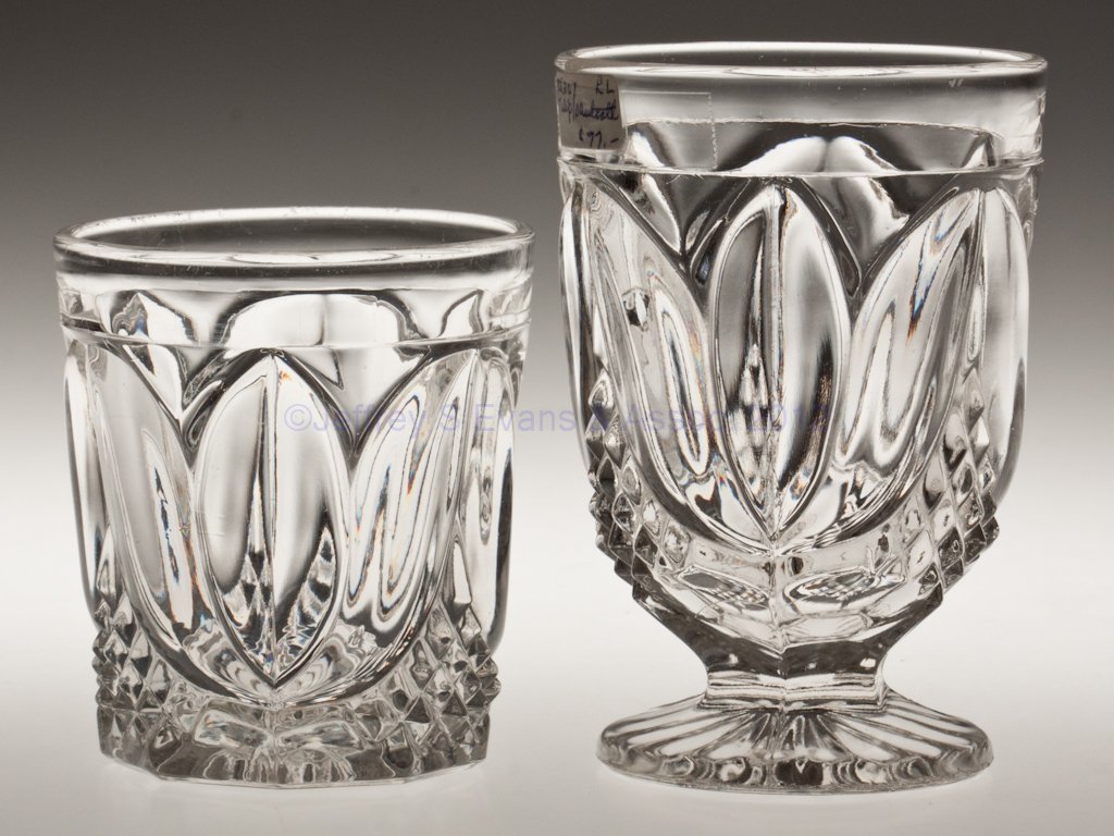 TULIP WITH SAWTOOTH TUMBLERS, LOT OF TWO: TULIP WITH SAWTOOTH TUMBLERS, LOT OF TWO, colorless lead glass, comprising a water tumbler with polished table ring and a footed example with rayed base. Third quarter 19th century. 3 1/2" and 4 3/4" 