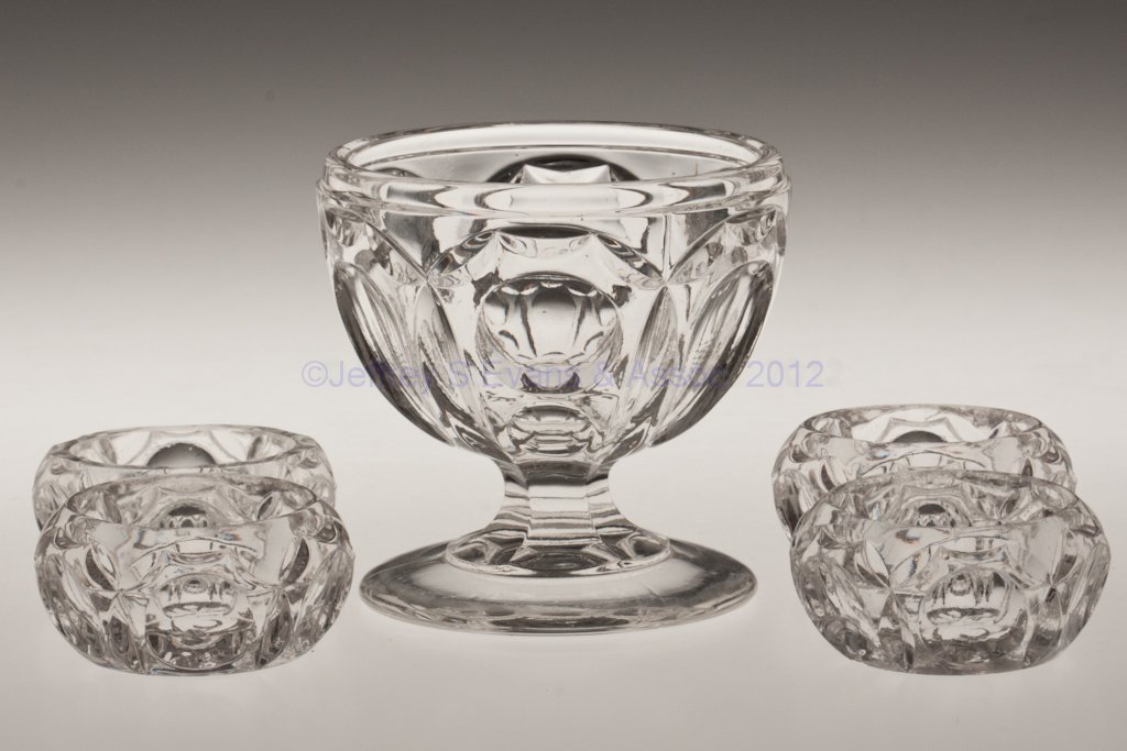 WASHINGTON SET OF FIVE SALTS: WASHINGTON SET OF FIVE SALTS, colorless lead glass, comprising a footed master salt and four individual salts. New England Glass Co. Third quarter 19th century. 2 3/4" H, 3" D rim, and 7/8" H, 1 7/8" 
