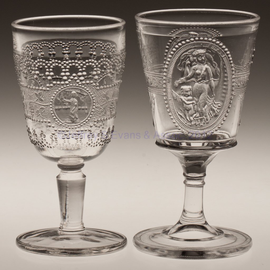 VARIOUS EAPG CHAMPAGNE GLASSES, LOT OF TWO: VARIOUS EAPG CHAMPAGNE GLASSES, LOT OF TWO, colorless. comprising Minerva, and Cupid and Venus. Fourth quarter 19th century. 4 7/8" and 5 1/8" H. Provenance: Collection of Walter "Bud" Marchant.