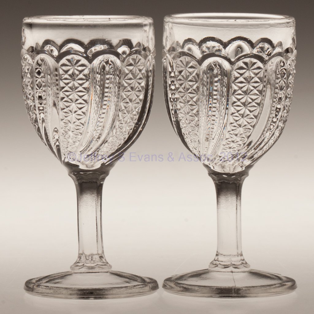 FEATHER PAIR OF CORDIAL GLASSES: FEATHER PAIR OF CORDIAL GLASSES, colorless, each with fire-polished rim. Late 19th/early 20th century. 3 1/8" H. Provenance: Personal collection of Judith (Judy) Cronin, Orleans, MA.