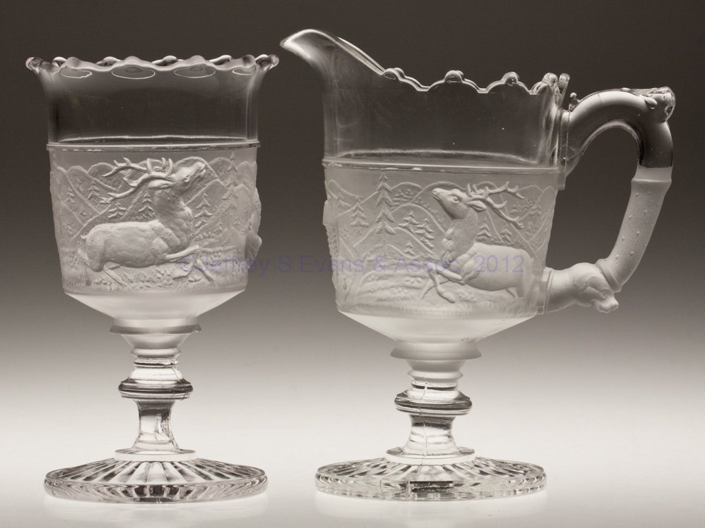 WESTWARD HO CREAMER AND SPOONER: WESTWARD HO CREAMER AND SPOONER, colorless and frosted. Gillinder & Sons. Fourth quarter 19th century. 6 7/8" and 6 1/2" HOA. Provenance: Personal collection of Judith (Judy) Cronin, Orleans, MA.