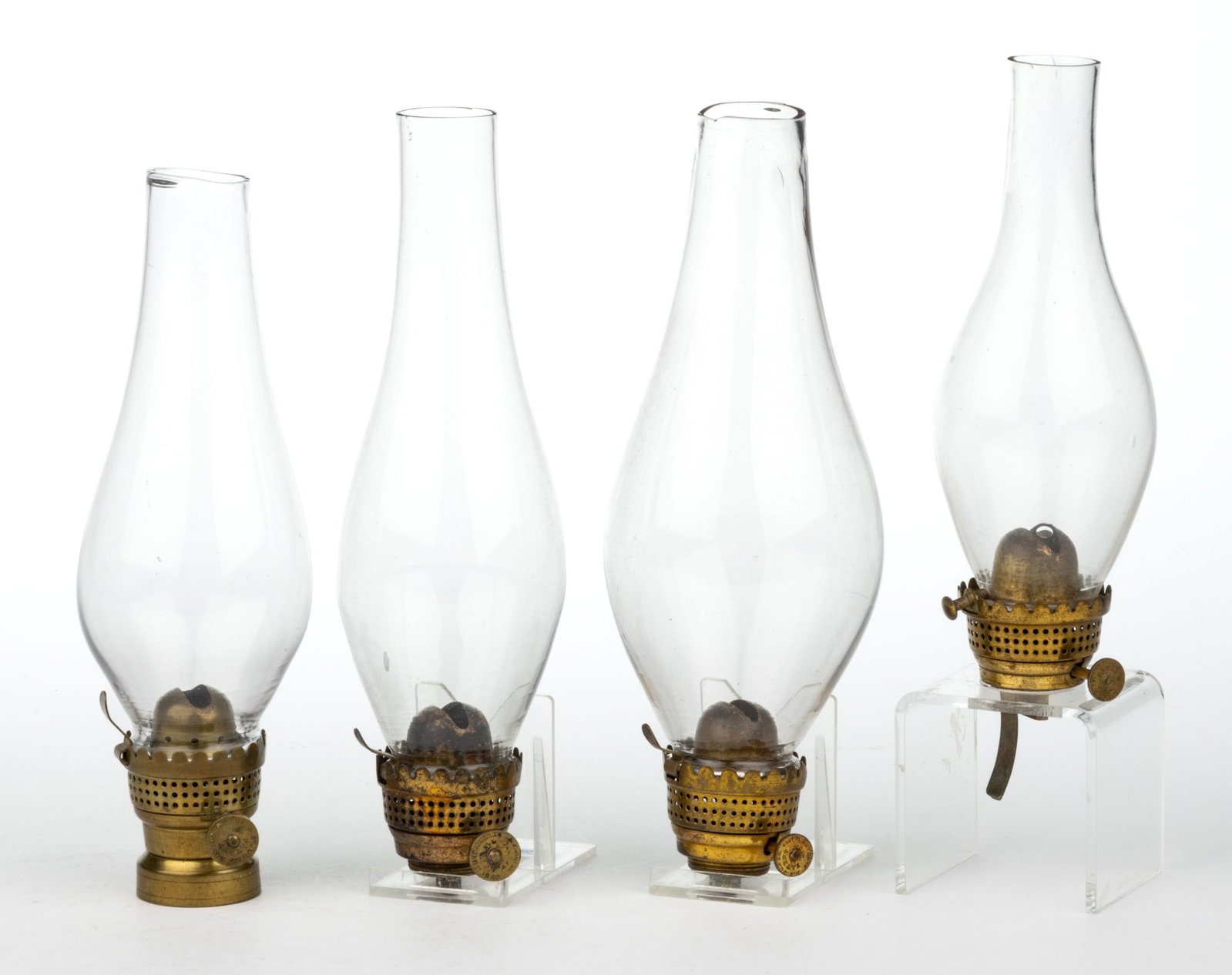 BRASS E. F. JONES AND ADLAMS NO. 0 LIP BURNERS, LOT OF FOUR: BRASS E. F. JONES AND ADLAMS NO. 0 LIP BURNERS, LOT OF FOUR, comprising three E. F. Jones examples, each thumbwheel marked "E. F. JONES" and with various other markings for dates, 
