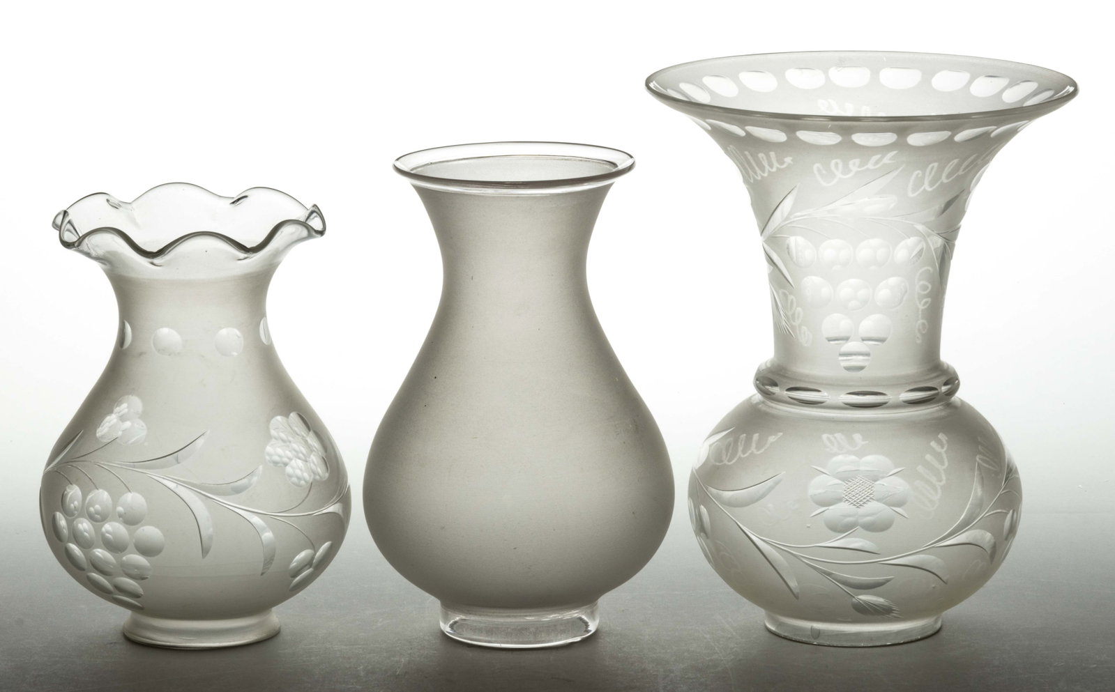 ASSORTED ARGAND, SOLAR AND OTHER LAMP SHADES, LOT OF THREE: ASSORTED ARGAND, SOLAR AND OTHER LAMP SHADES, LOT OF THREE, colorless and frosted, baluster forms, comprising two examples with cut and engraved foliage pattern, largest example with flared smooth rim