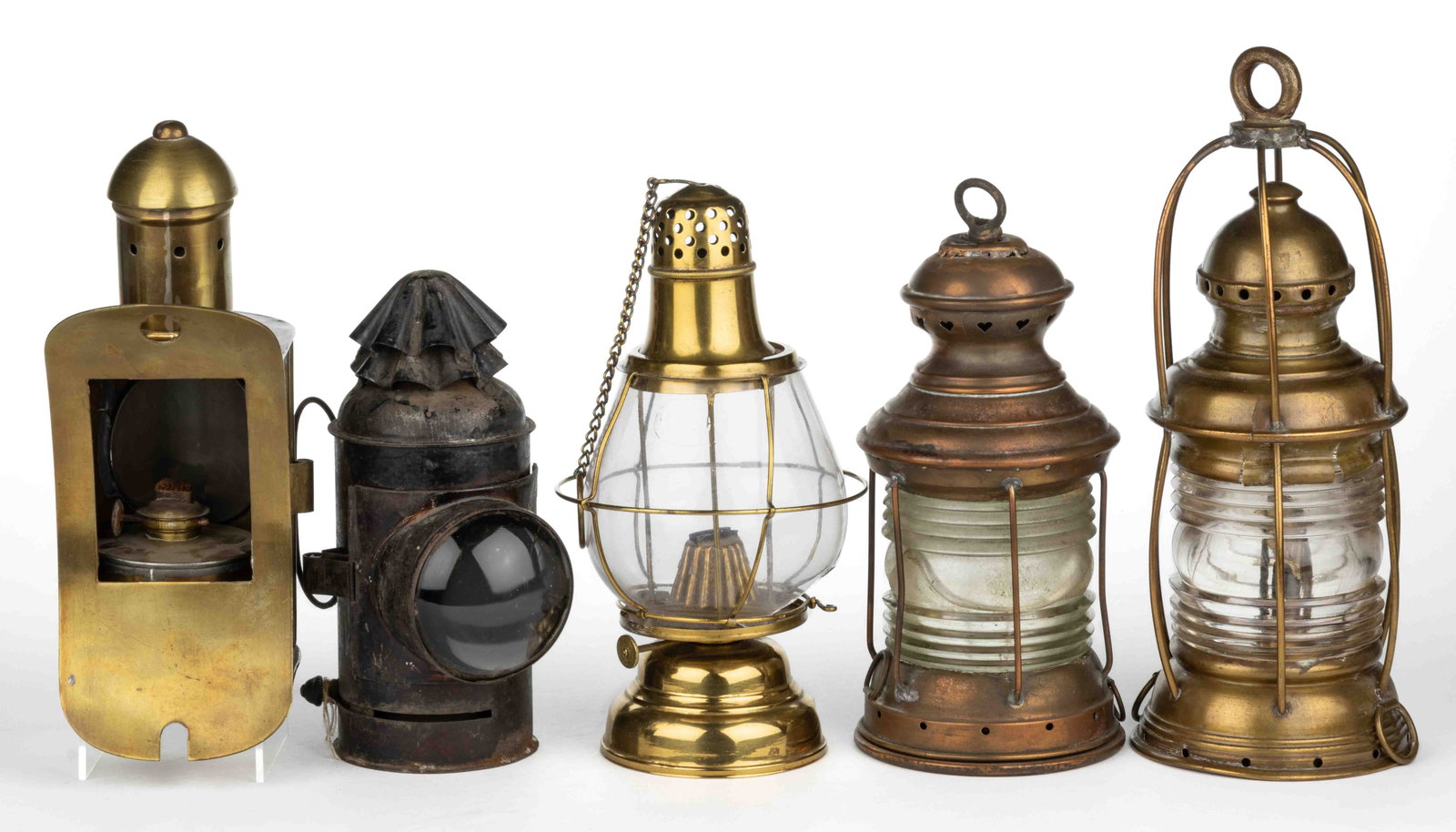 ASSORTED BRASS AND SHEET-IRON TRANSPORTATION LANTERNS, LOT OF FIVE: ASSORTED BRASS AND SHEET-IRON TRANSPORTATION LANTERNS, LOT OF FIVE, comprising two brass anchor examples with fresnel lenses; a brass binnacle example; a brass Holmes, Booth & Haydens example