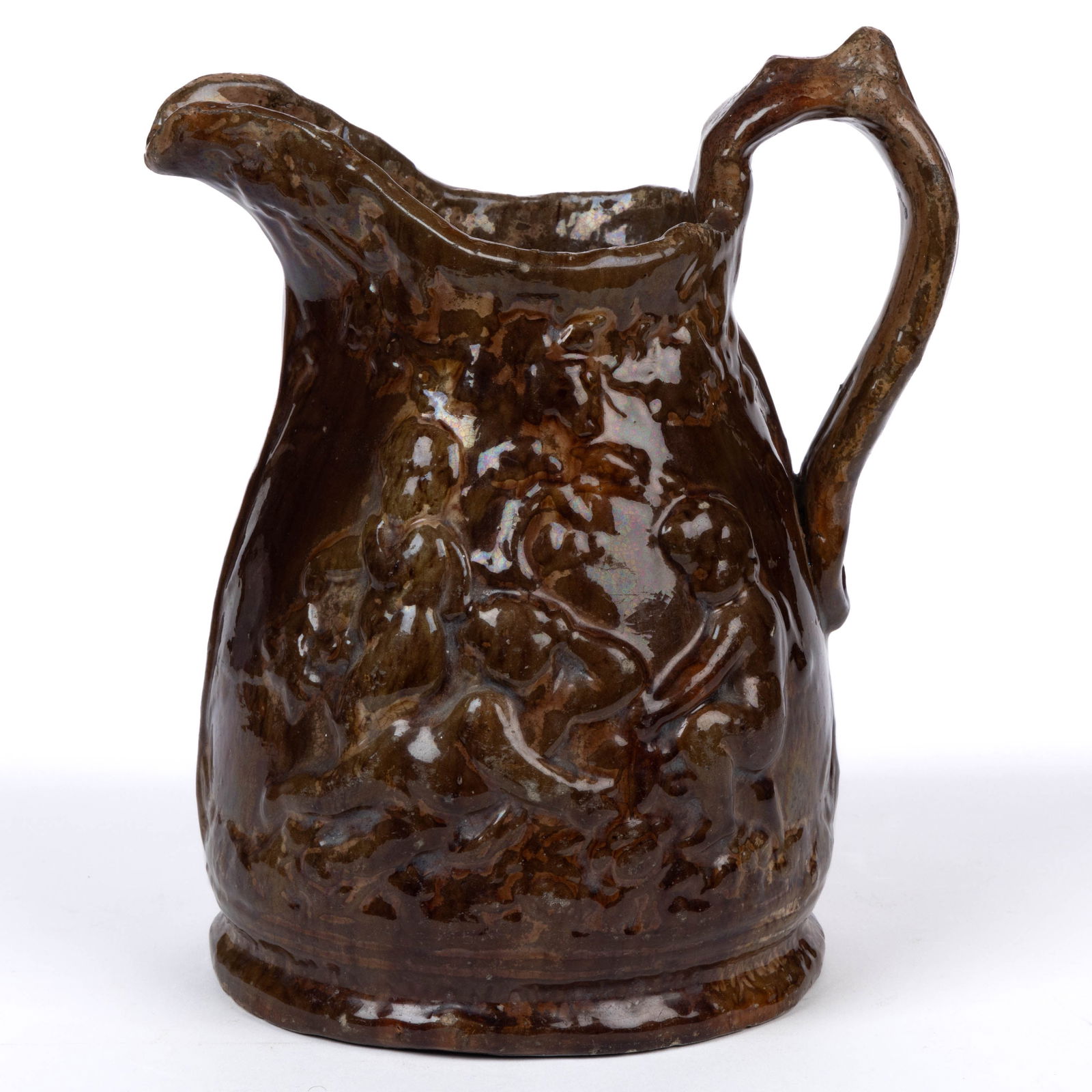 STAMPED "SOLOMON BELL / STRASBURG / VA" SHENANDOAH VALLEY OF VIRGINIA EARTHENWARE / REDWARE PITCHER: STAMPED "SOLOMON BELL / STRASBURG / VA" SHENANDOAH VALLEY OF VIRGINIA EARTHENWARE / REDWARE PITCHER, mottled brown glaze, molded scenes to each side featuring carefree putti with vine design