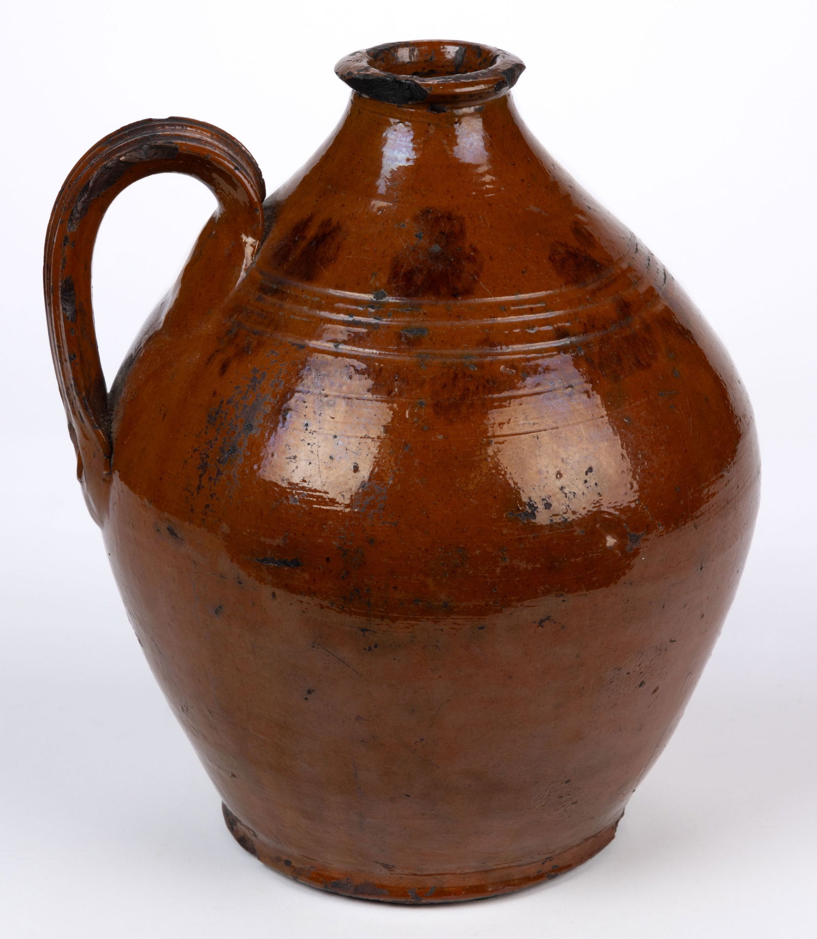 NEW YORK OR PENNSYLVANIA DECORATED EARTHENWARE / REDWARE JUG: NEW YORK OR PENNSYLVANIA DECORATED EARTHENWARE / REDWARE JUG, lead-glazed with manganese splotches, approximately one-gallon capacity, ovoid form with flattened mouth, three incised shoulder ring