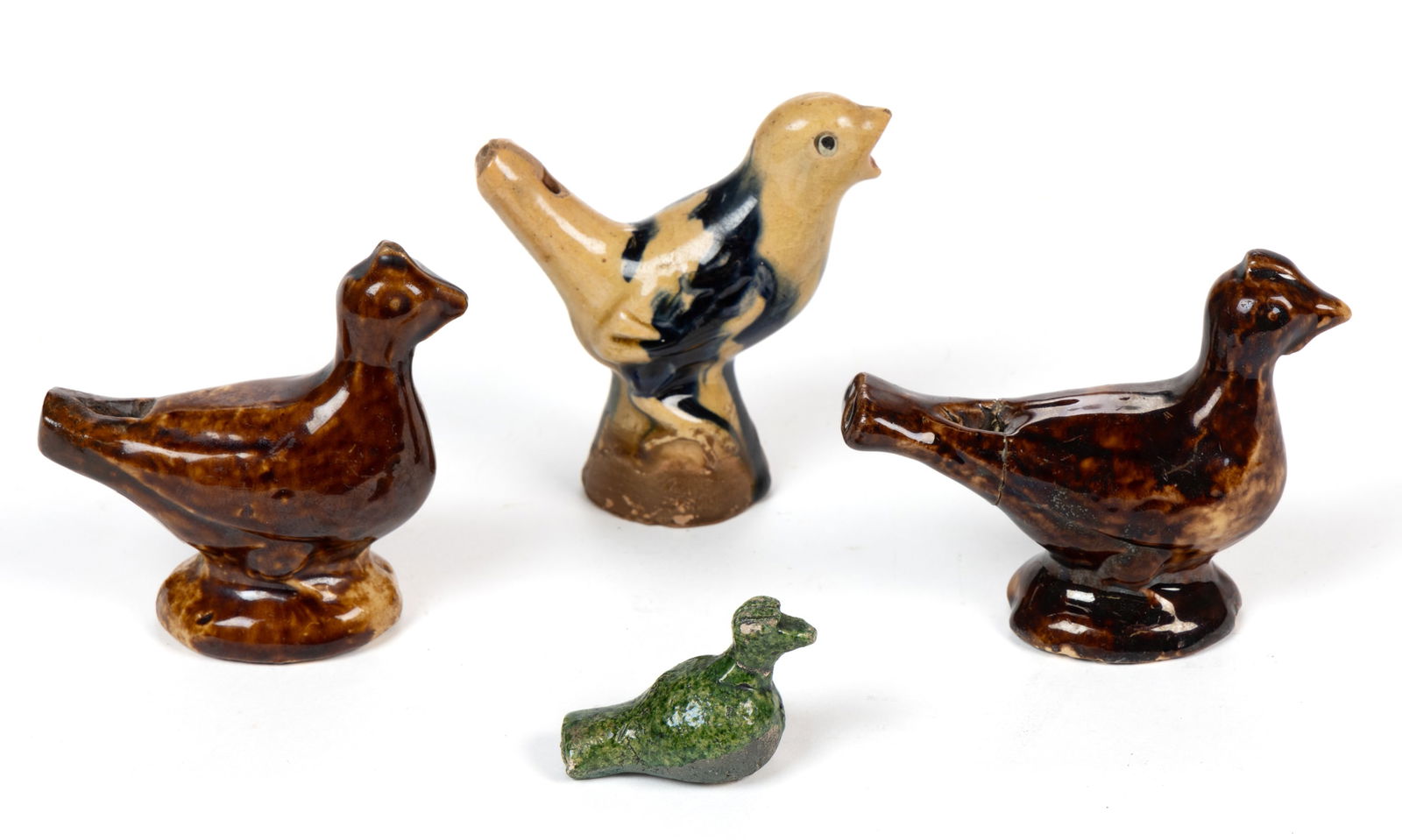 ASSORTED EARTHENWARE / REDWARE FIGURAL BIRD WHISTLES, LOT OF FOUR: ASSORTED EARTHENWARE / REDWARE FIGURAL BIRD WHISTLES, LOT OF FOUR, comprising one small green-glazed example and three examples perched on a domed ovoid base including one yellowwa