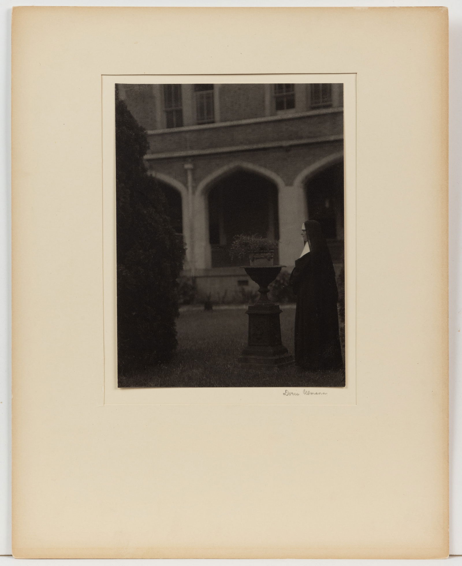 DORIS ULMANN (AMERICAN, 1882-1934) NEW ORLEANS CONVENT NUN PHOTOGRAPHIC PORTRAIT: DORIS ULMANN (AMERICAN, 1882-1934) NEW ORLEANS CONVENT NUN PHOTOGRAPHIC PORTRAIT, platinum print depicting a nun wearing a traditional tunic and habit standing in the Sisters of the Holy Family courty