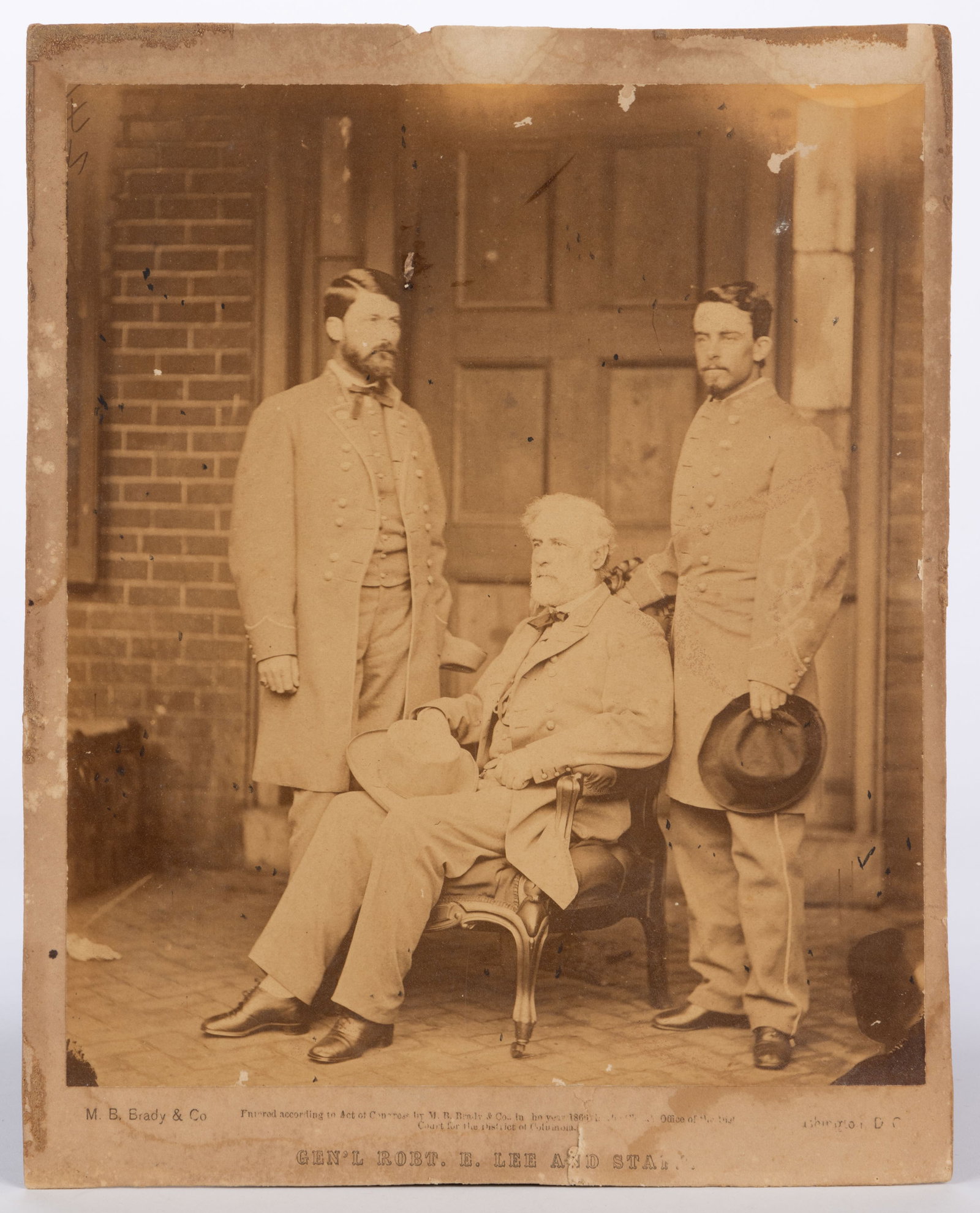 RARE MATTHEW BRADY (AMERICAN, 1822-1896) PHOTOGRAPH OF GENERAL ROBERT E. LEE AND STAFF: RARE MATTHEW BRADY (AMERICAN, 1822-1896) PHOTOGRAPH OF GENERAL ROBERT E. LEE AND STAFF, albumen print on cardstock, depicting Lee seated in a Rococo Revival armchair with his son, General George