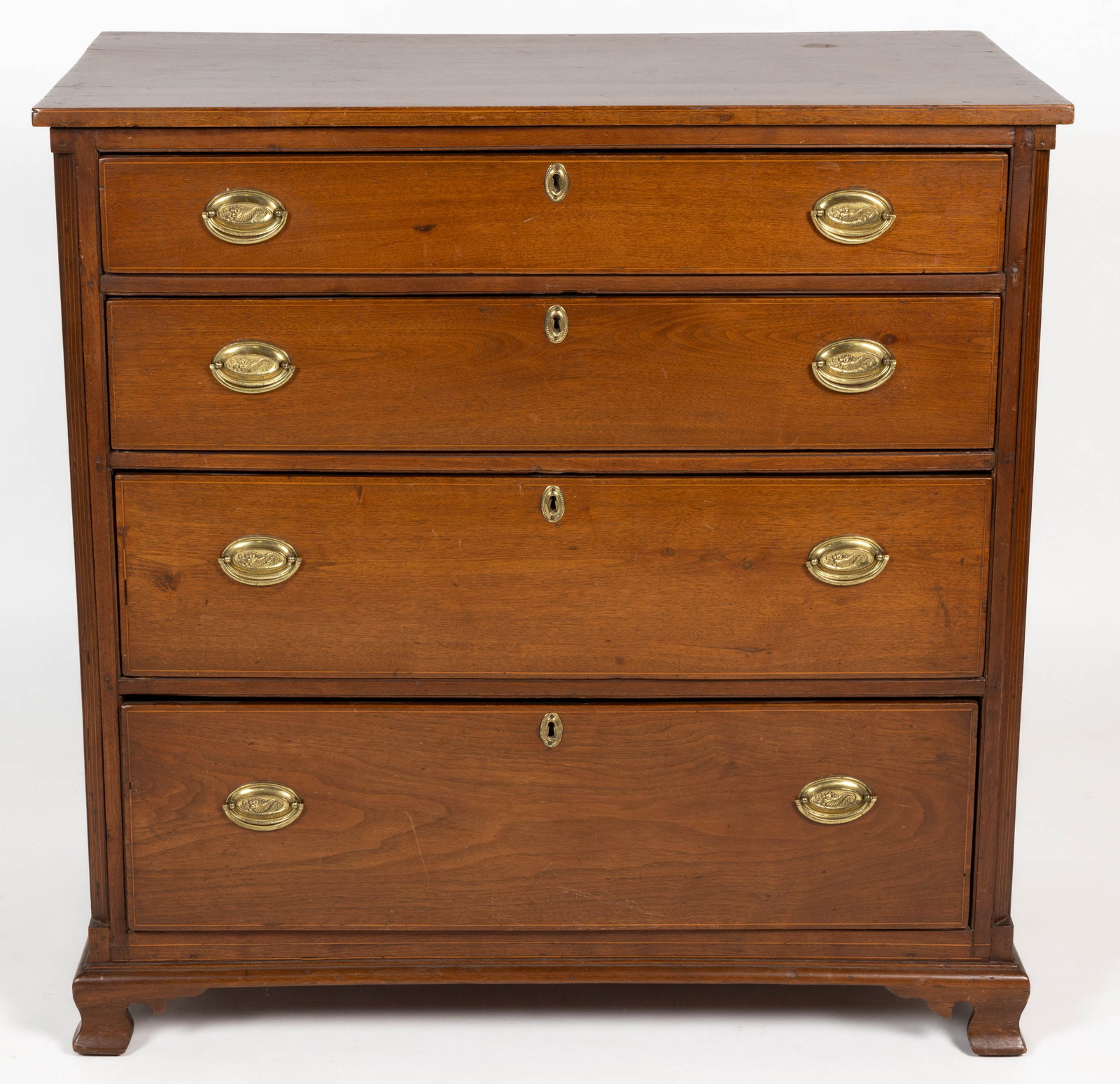 AMERICAN, PROBABLY PENNSYLVANIA, FEDERAL INLAID WALNUT CHEST OF DRAWERS: AMERICAN, PROBABLY PENNSYLVANIA, FEDERAL INLAID WALNUT CHEST OF DRAWERS, the rectangular top with plain string on the edge, the four graduated drawers each also outlined in string inlaid are flanked b