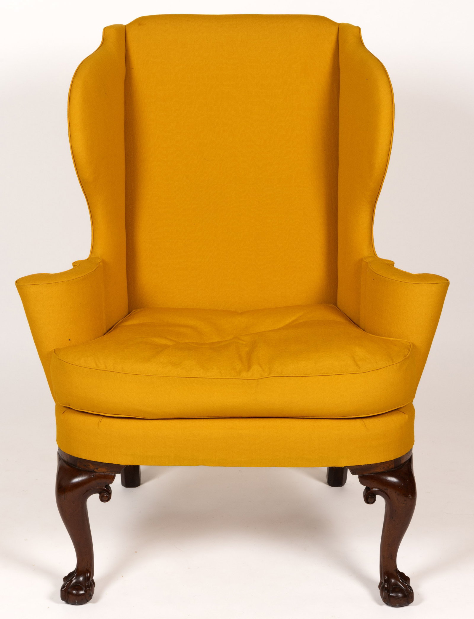 ENGLISH GEORGE III CARVED MAHOGANY WING CHAIR: ENGLISH GEORGE III CARVED MAHOGANY WING CHAIR, well-shaped frame with upright arm supports and loose cushion, raised on cabriole front legs terminating in ball-and-claw feet and curved 