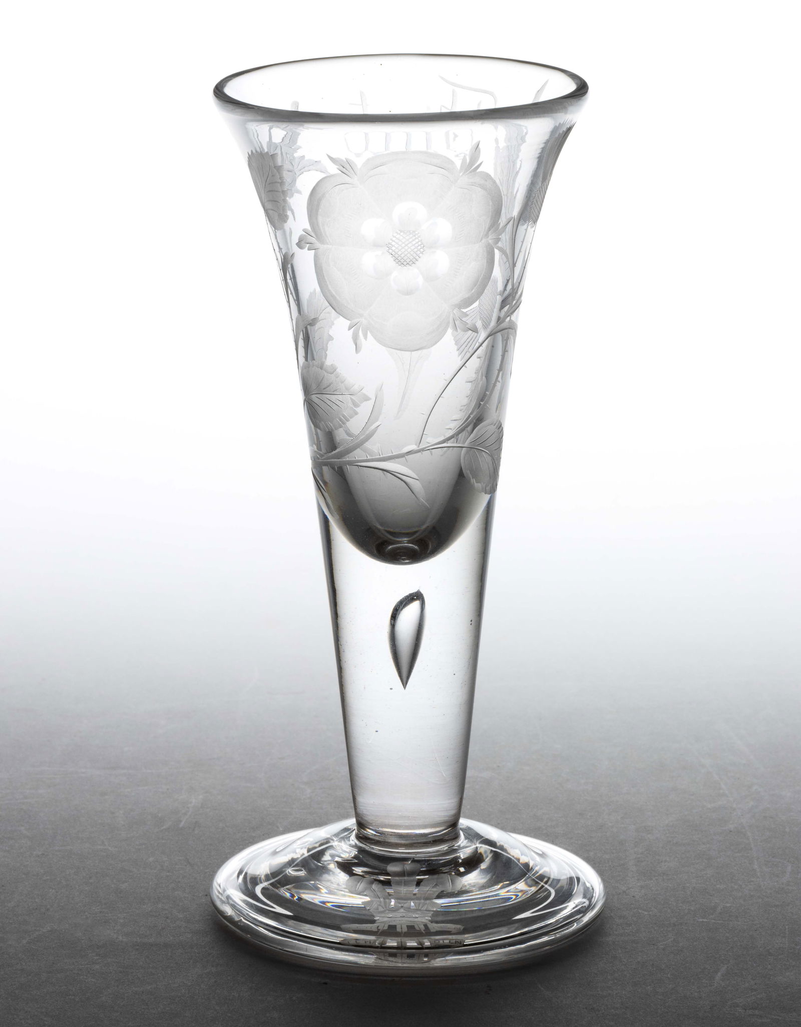 ENGLISH FREE-BLOWN STRAIGHT STEM ALE / WINE GLASS: ENGLISH FREE-BLOWN STRAIGHT STEM ALE / WINE GLASS, colorless lead glass, the trumpet bowl atop an extraordinarily thick drawn stem with single tear, conical foot with folded rim and rough pontil mark;