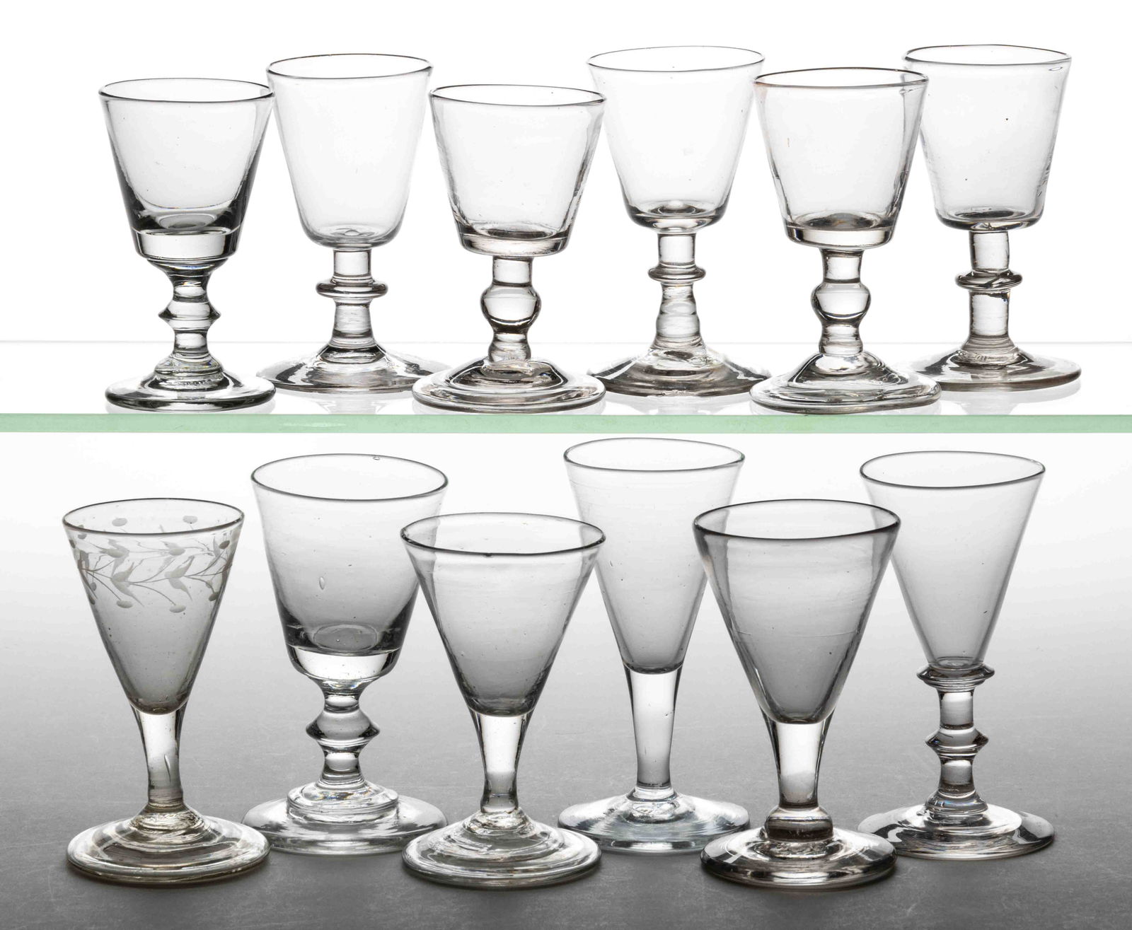 ASSORTED FREE-BLOWN WINE GLASSES, LOT OF 12: ASSORTED FREE-BLOWN WINE GLASSES, LOT OF 12, colorless lead and non-lead, including a conical-bowl example with engraved leaf and berry design and folded foot, three others with a folded foot, and six