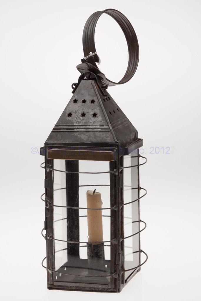 E. J. PARKER'S PATENT PIERCED SHEET IRON CANDLE LANT: E. J. PARKER'S PATENT PIERCED SHEET IRON CANDLE LANTERN, square-form with large strap handle, pierced star pattern to top on each side, removable colorless glass panes with guards on each side and inc