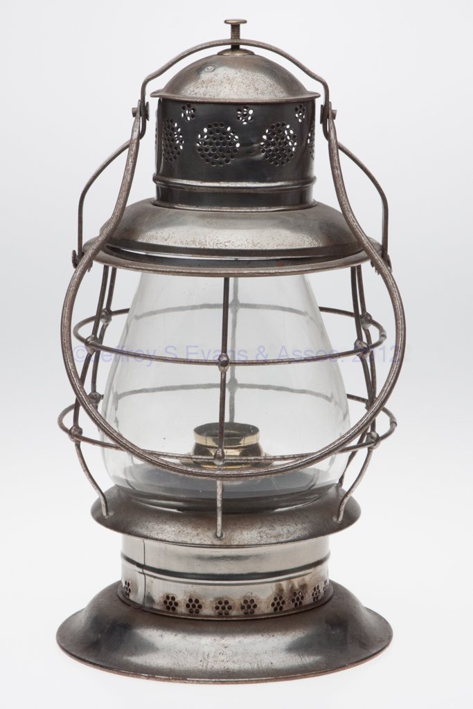 PETER GRAY "THOMPSON" SHEET IRON RAILROAD LANTERN: PETER GRAY "THOMPSON" SHEET IRON RAILROAD LANTERN, bail handle attached to frame arm which secures a removable cap, base impressed "PAT SEPT 29 1874", colorless globe with wire guard, removable sheet 