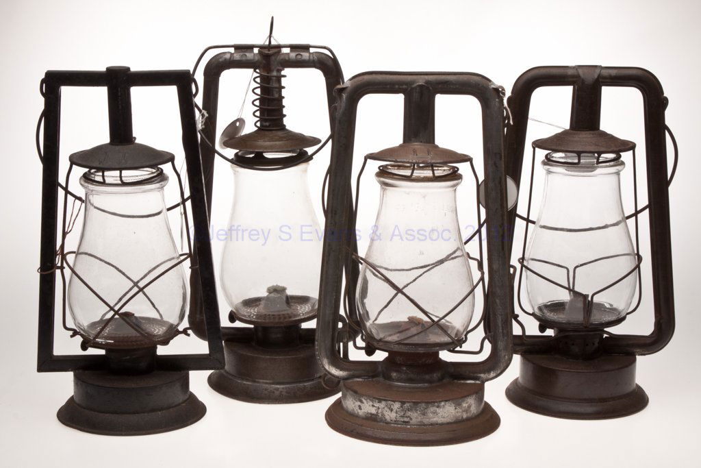 SHEET IRON HOT BLAST TUBULAR LANTERNS, LOT OF FOUR: SHEET IRON HOT BLAST TUBULAR LANTERNS, LOT OF FOUR, each with bail handle and colorless globe, comprising two Steam Gauge & Lantern Co. examples including "Square Lift" and a "No. 0" with spiral sprin