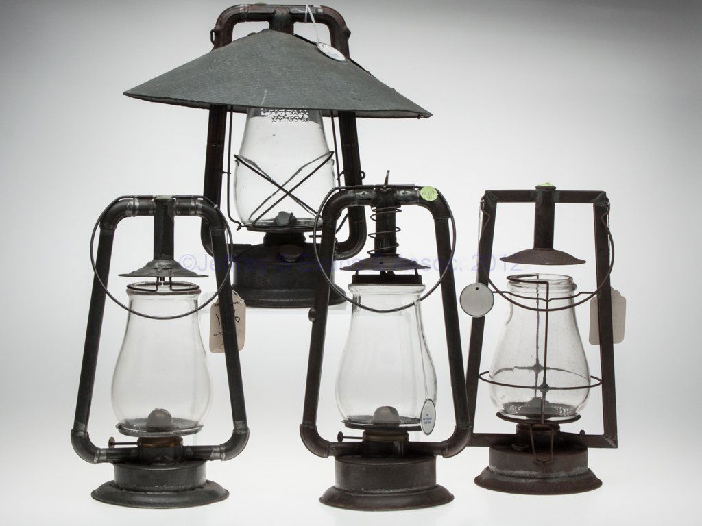 SHEET IRON HOT BLAST TUBULAR LANTERNS, LOT OF FOUR: SHEET IRON HOT BLAST TUBULAR LANTERNS, LOT OF FOUR, each with bail handle and colorless globe, comprising a Steam Gauge & Lantern Co. "OK Tubular"; a Dietz "Monarch" with reflector, globe embossed "DI