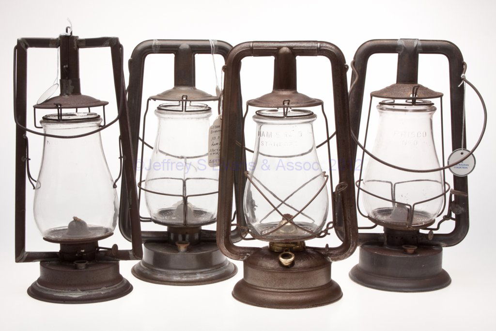 SHEET IRON HOT BLAST TUBULAR LANTERNS, LOT OF FOUR: SHEET IRON HOT BLAST TUBULAR LANTERNS, LOT OF FOUR, each with bail handle and colorless globe, comprising two C. T. Ham Mfg. Co. examples, including a "No. 0 Clipper" and a "No. 0 Tubular", globes emb