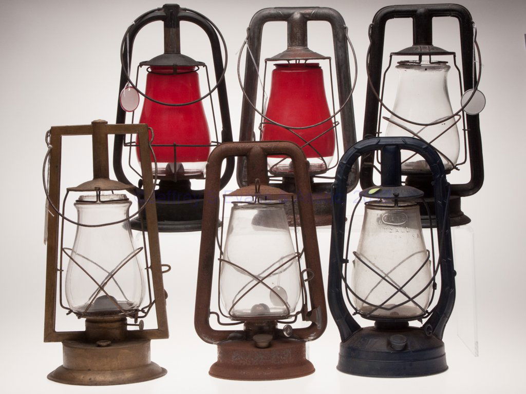 SHEET IRON HOT BLAST TUBULAR LANTERNS, LOT OF SIX: SHEET IRON HOT BLAST TUBULAR LANTERNS, LOT OF SIX, each with bail handle and colorless globe, comprising three Dietz examples, including two "Monarch" examples, one painted blue and other black, one w