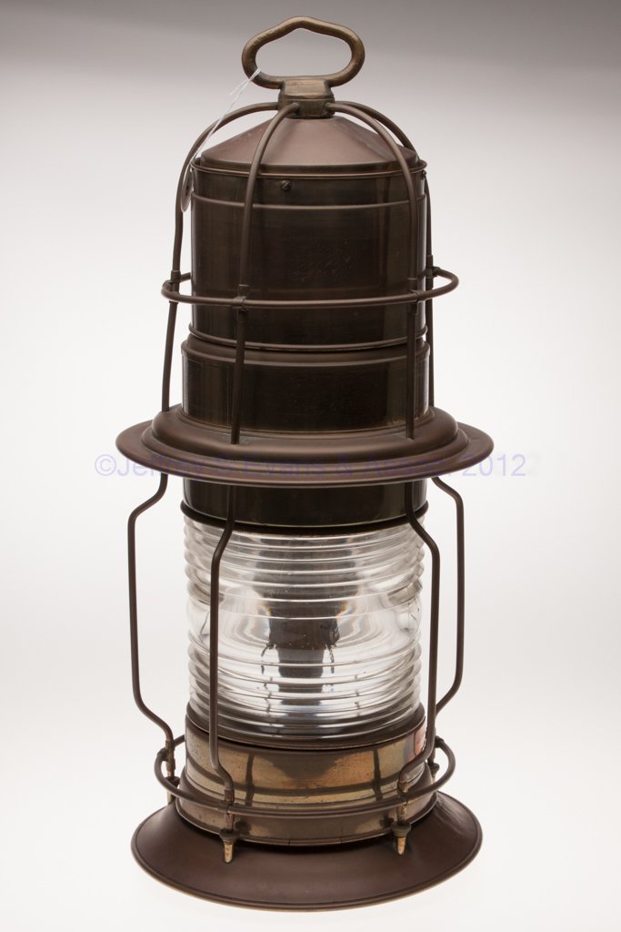 BRASS "POST LANTERN" LIGHTHOUSE SIGNAL MARINE LANT: BRASS "POST LANTERN" LIGHTHOUSE SIGNAL MARINE LANTERN, ring handle, base with a brass plate marked "POST LANTERN", colorless 360 degree fresnel lens with heavy wire guards, removable font to underside
