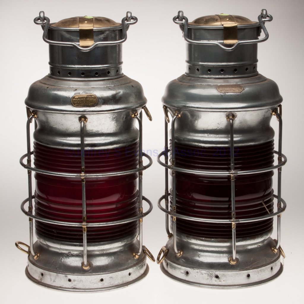 A. WARD HENDRICKSON & CO. BRASS AND SHEET IRON ANC: A. WARD HENDRICKSON & CO. BRASS AND SHEET IRON ANCHOR MARINE LANTERNS, PAIR, each with silver protective covering, bail handles, hinged cap, maker's plate marked "MARINE LIGHTING A. WARD HENDRICKSON &