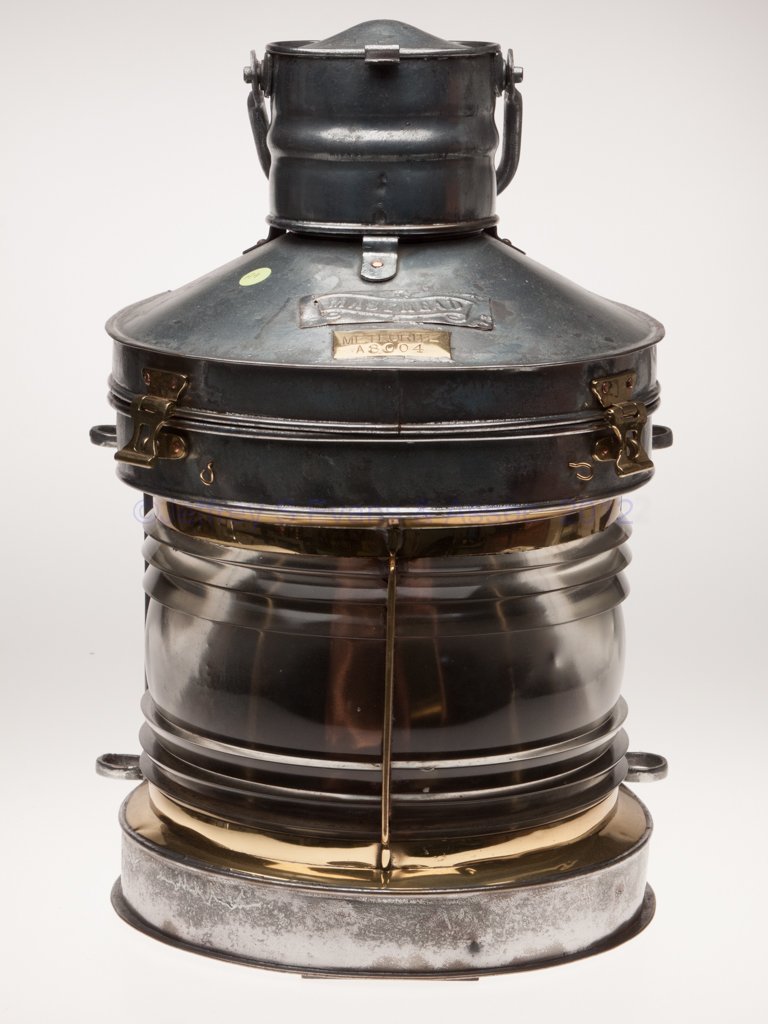 METEORITE BRASS AND GALVANIZED SHEET IRON MASTHEAD: METEORITE BRASS AND GALVANIZED SHEET IRON MASTHEAD MARINE LANTERN, with brass and copper fittings, bail handle, hinged cap and cover, flat back and four mounting lugs, cover with a silver finished bra