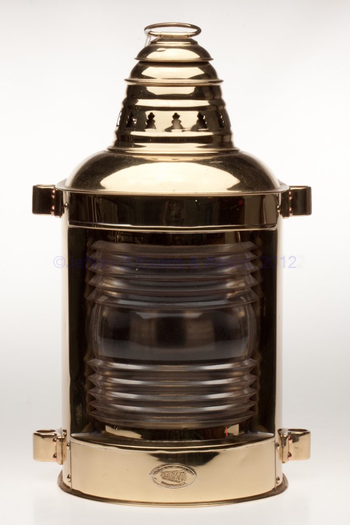 PERKINS "PERKO" BRASS BOW / MASTHEAD MARINE LANTER: PERKINS "PERKO" BRASS BOW / MASTHEAD MARINE LANTERN, polished, ring handle and flat back, base with maker's label marked "PERKINS MARINE LAMP & HDWE CORP / PERKO / BROOKLYN, N.Y., U.S.A.", top and bot