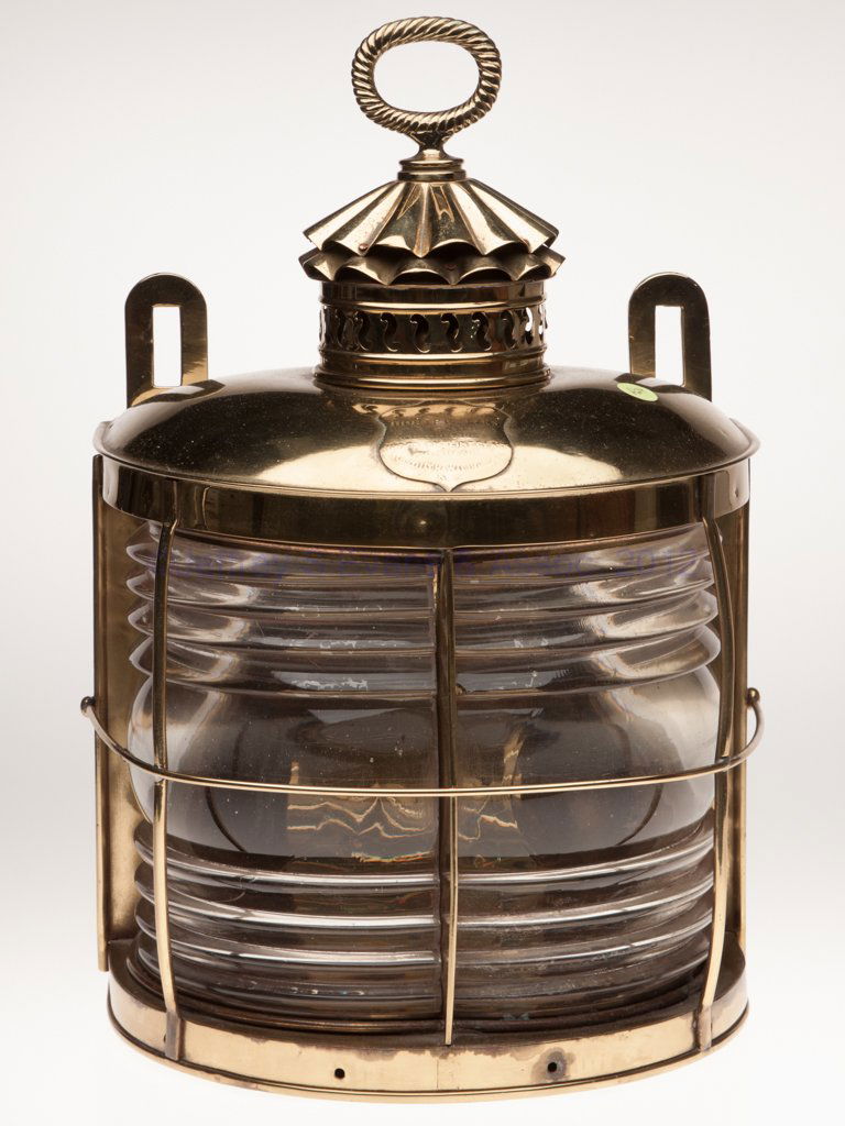 BRASS MASTHEAD MARINE LANTERN: BRASS MASTHEAD MARINE LANTERN, polished, rope twist form ring handle, flat back with hinged door and two mounting tabs, sides with four tie-down rings, cover with shield marked "GILLILAND'S DIOPTRIC L