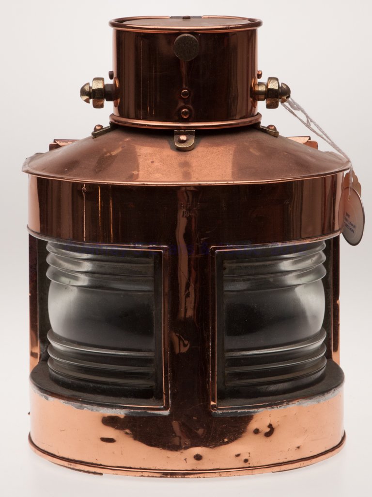 G. P. LD BRASS AND COPPER MARINE LANTERN: G. P. LD BRASS AND COPPER MARINE LANTERN, polished, cast brass bail handle with mounting bracket, hinged cap, flat back with sliding door, numerous marked "G. P. LD 1943" impressions, two colorless fr