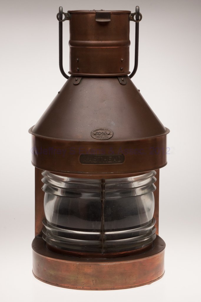 ELI GRIFFITHS & SONS COPPER MASTHEAD MARINE LANTER: ELI GRIFFITHS & SONS COPPER MASTHEAD MARINE LANTERN, iron bail handle with brass mounts and hinged cover, flat back with sliding door, maker's plate marked "ELI GRIFFITHS & SONS LTD BIRMINGHAM / NO 45