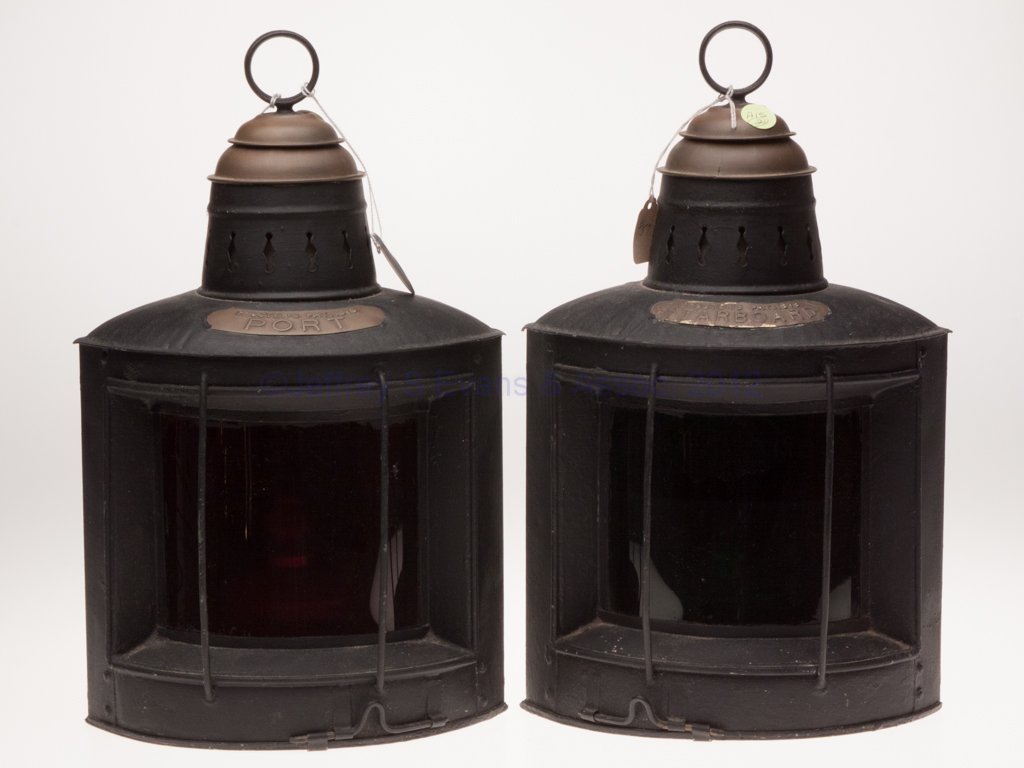 ROBERT W. PROCTOR BRASS AND GALVANIZED SHEET IRON : ROBERT W. PROCTOR BRASS AND GALVANIZED SHEET IRON PORT AND STARBOARD RUNNING MARINE LANTERNS, PAIR, later black paint applied to sheet iron, iron ring handle, triangular form with two flat sides inclu