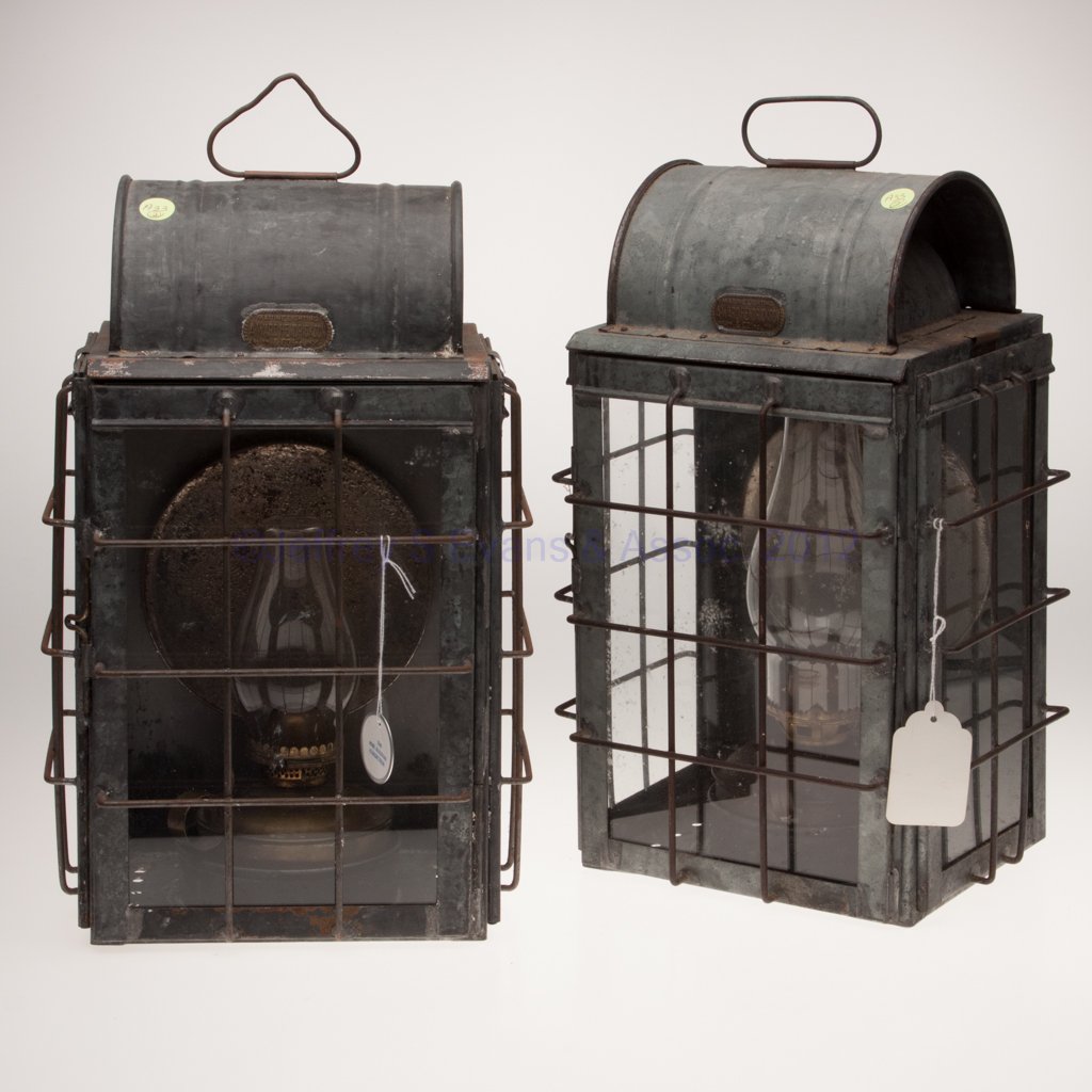 A. WARD HENDRICKSON & CO. GALVANIZED SHEET IRON BU: A. WARD HENDRICKSON & CO. GALVANIZED SHEET IRON BULKHEAD MARINE LANTERNS, PAIR, each with wire handle, rectangular form with contoured top, brass maker's plate marked "MARINE LIGHTING A. WARD HENDRICK
